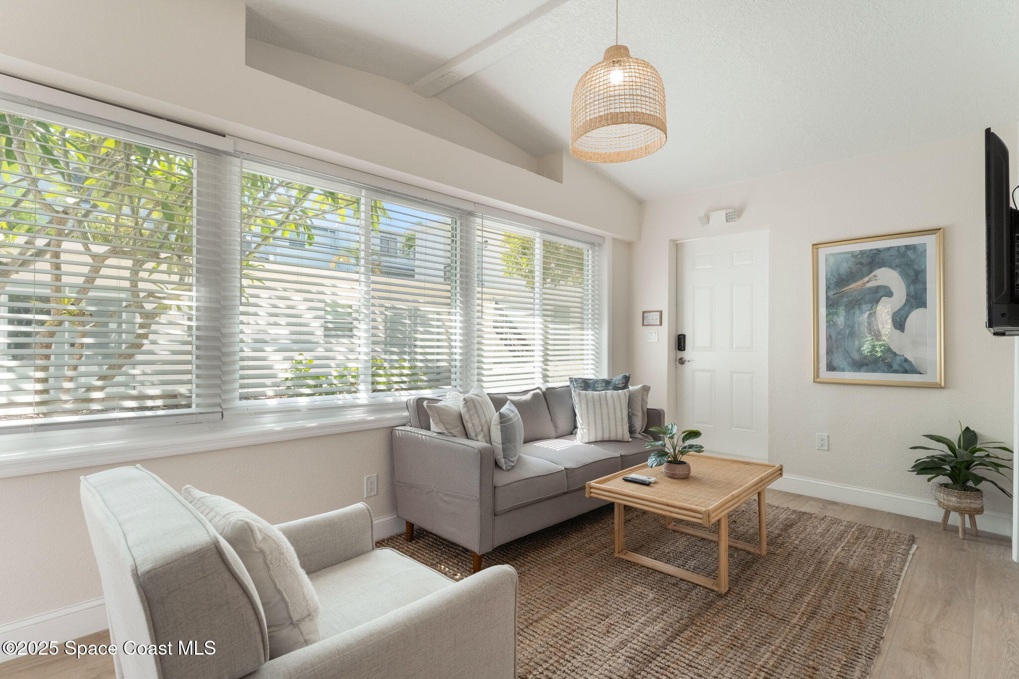 637 South Orlando Avenue Cocoa Beach, FL 32931 - Photo 18 of 83 a living room with furniture and a large window