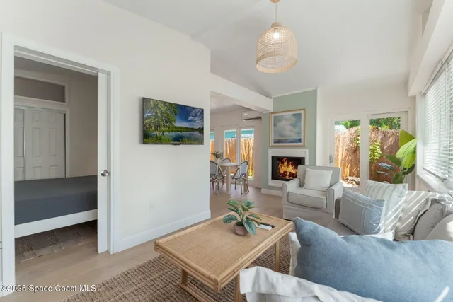 a view of a house with potted plants and a large window