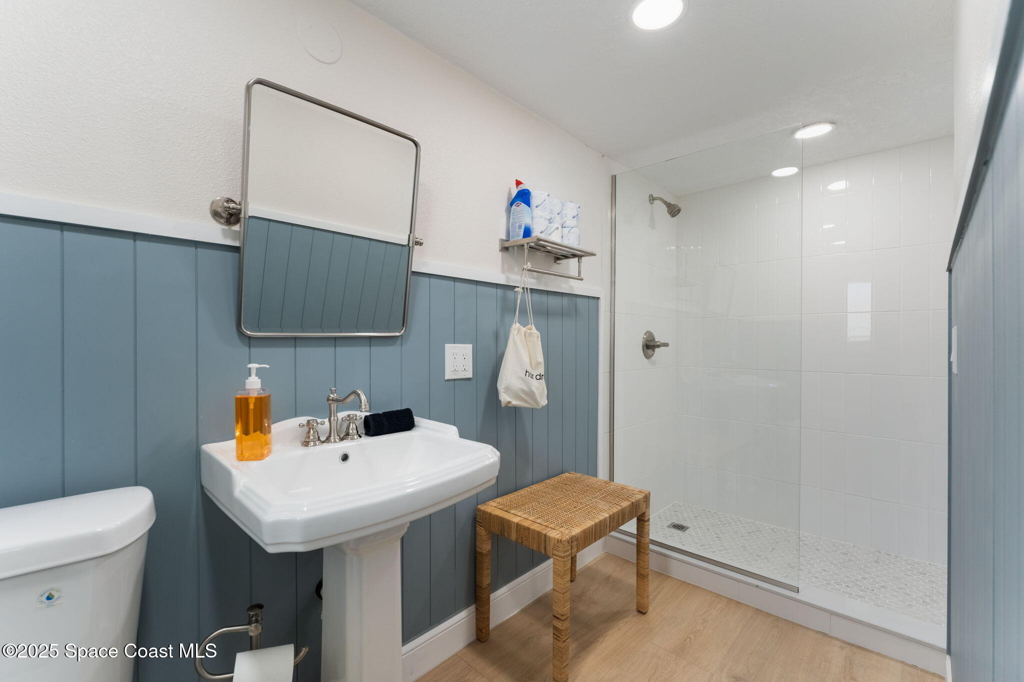637 South Orlando Avenue Cocoa Beach, FL 32931 - Photo 26 of 83 a bathroom with a sink a toilet and mirror