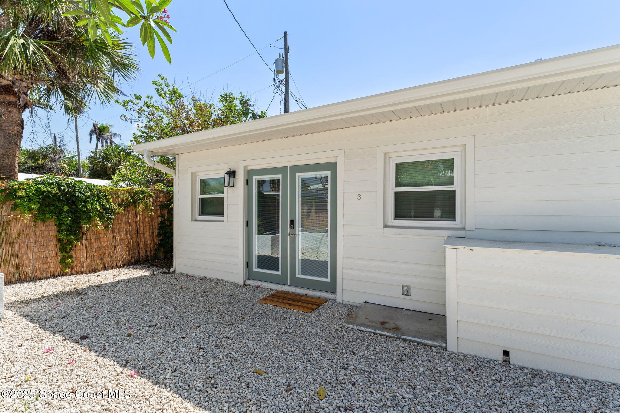 637 South Orlando Avenue Cocoa Beach, FL 32931 - Photo 27 of 83 a view of a house with potted plants and a large window