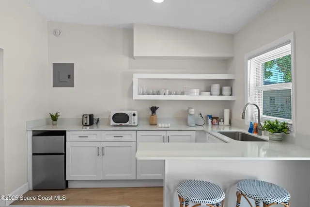 a kitchen with stainless steel appliances granite countertop a refrigerator a stove a sink and a microwave