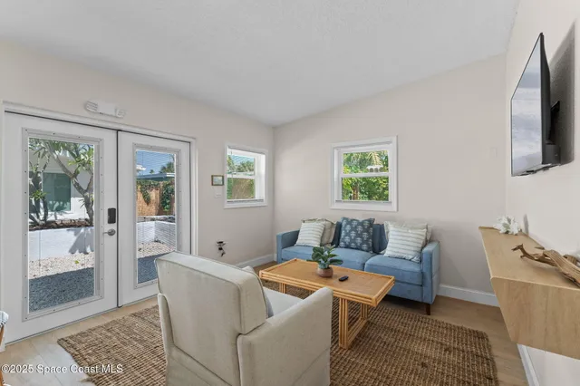 a bedroom with a bed and a dresser next to a window