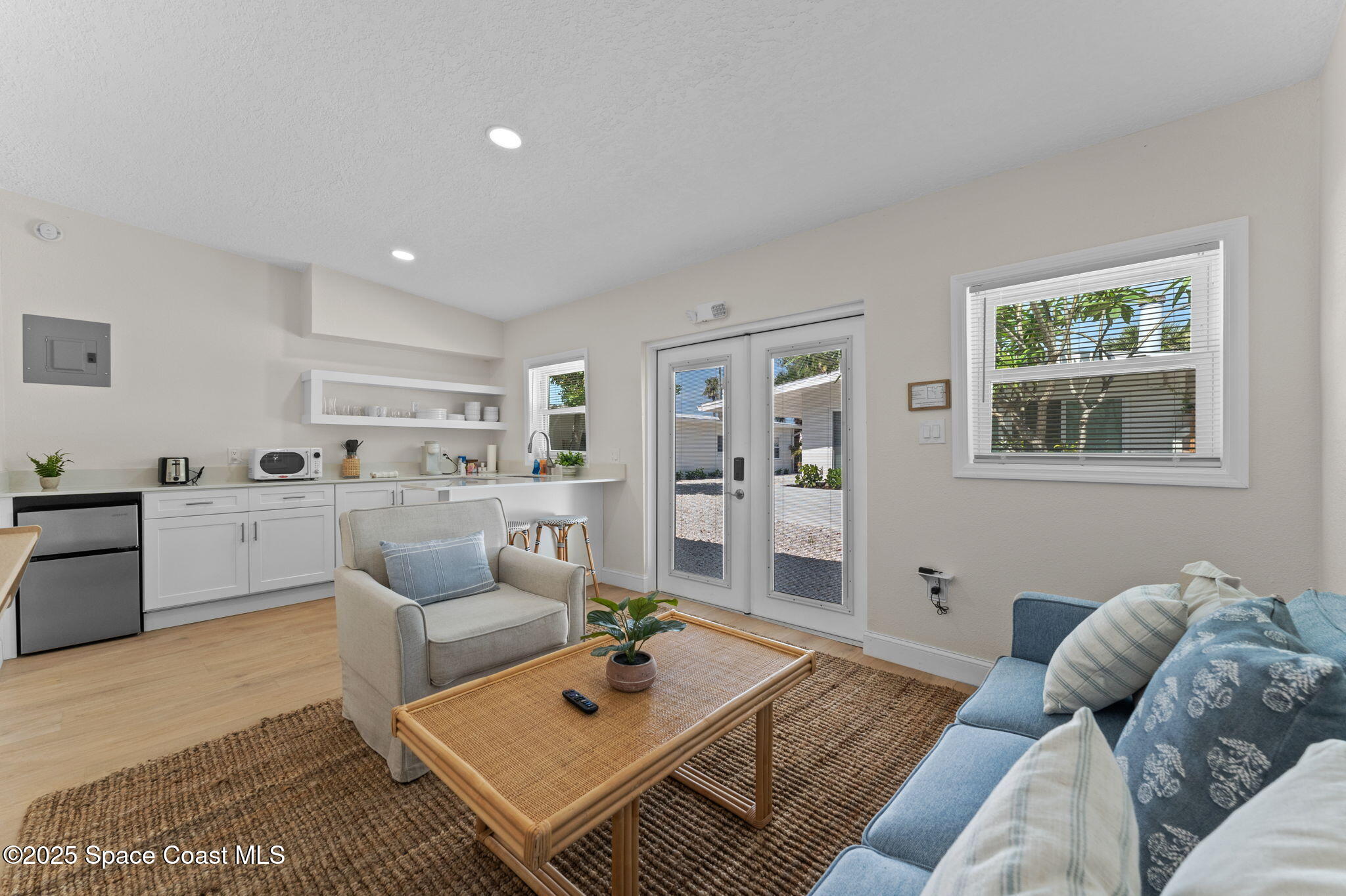 637 South Orlando Avenue Cocoa Beach, FL 32931 - Photo 32 of 83 a living room with furniture rug and window
