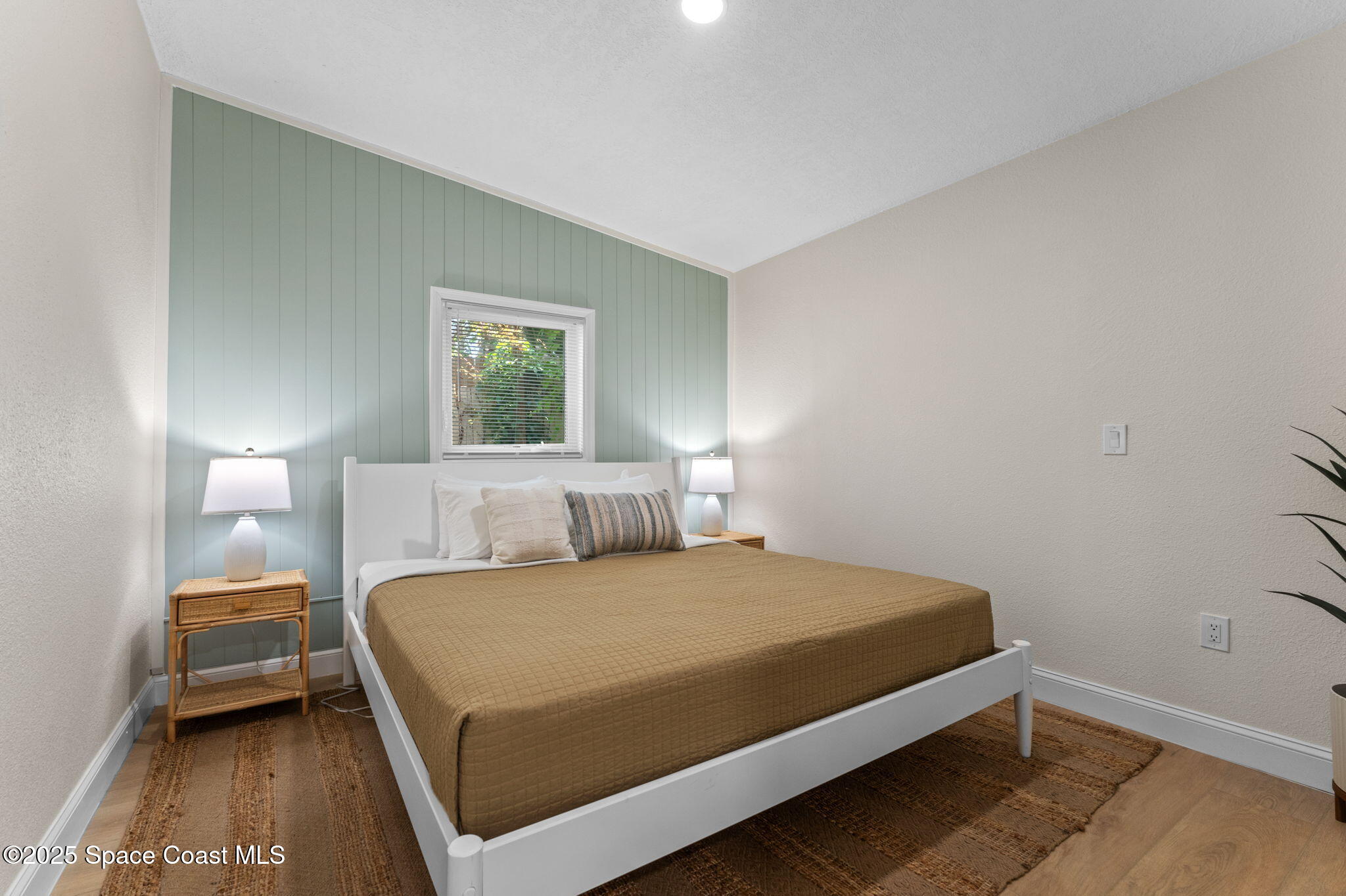 637 South Orlando Avenue Cocoa Beach, FL 32931 - Photo 33 of 83 a bedroom with a bed and a night stand