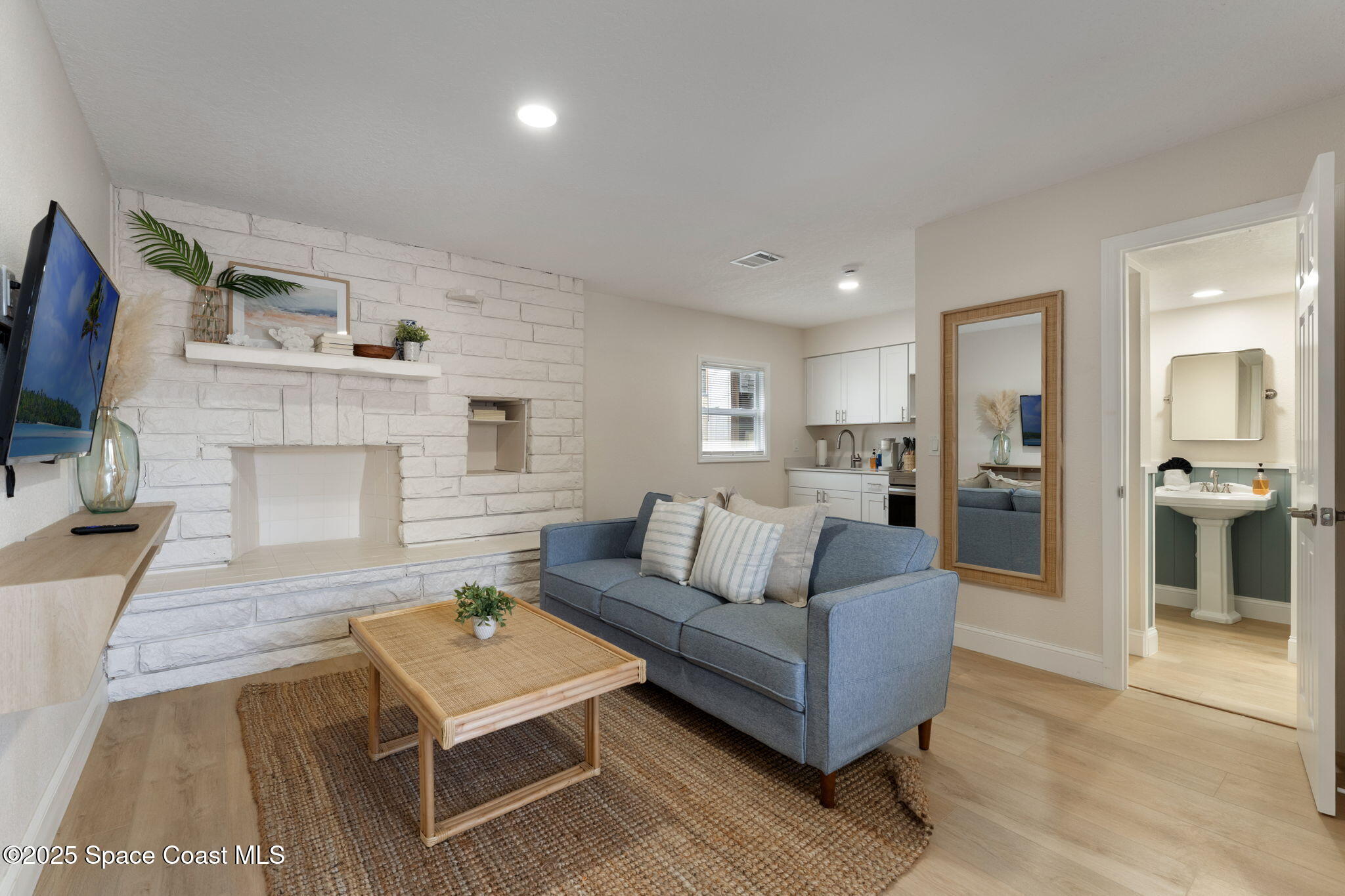 637 South Orlando Avenue Cocoa Beach, FL 32931 - Photo 36 of 83 a living room with furniture and a fireplace