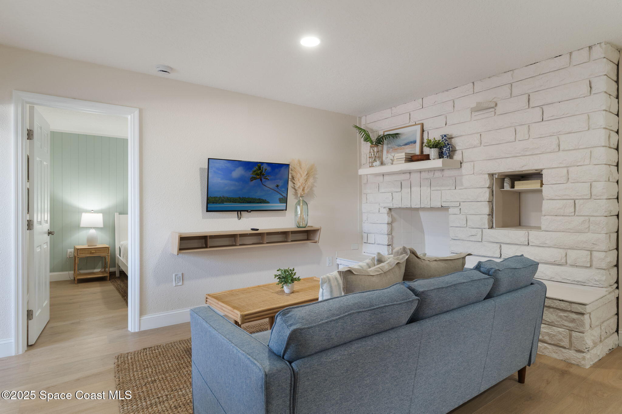 637 South Orlando Avenue Cocoa Beach, FL 32931 - Photo 37 of 83 a living room with furniture and a flat screen tv
