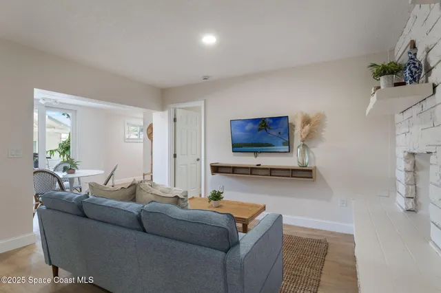 a living room with furniture and a dining table