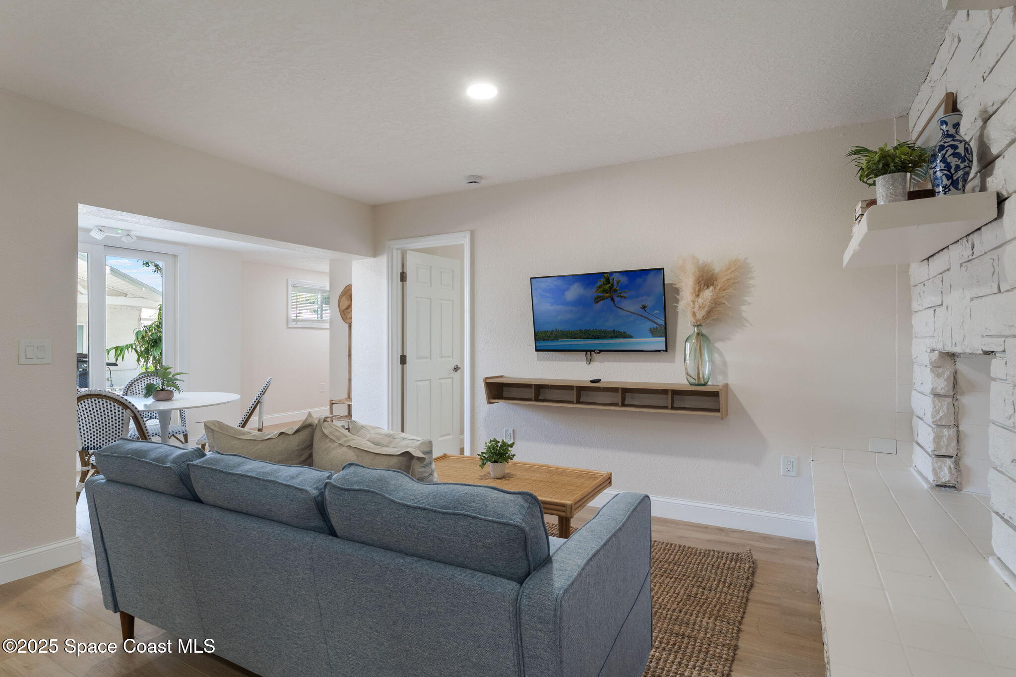 637 South Orlando Avenue Cocoa Beach, FL 32931 - Photo 38 of 83 a living room with furniture and a flat screen tv