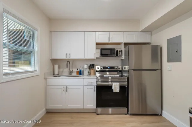 a bedroom with a large bed and a large window