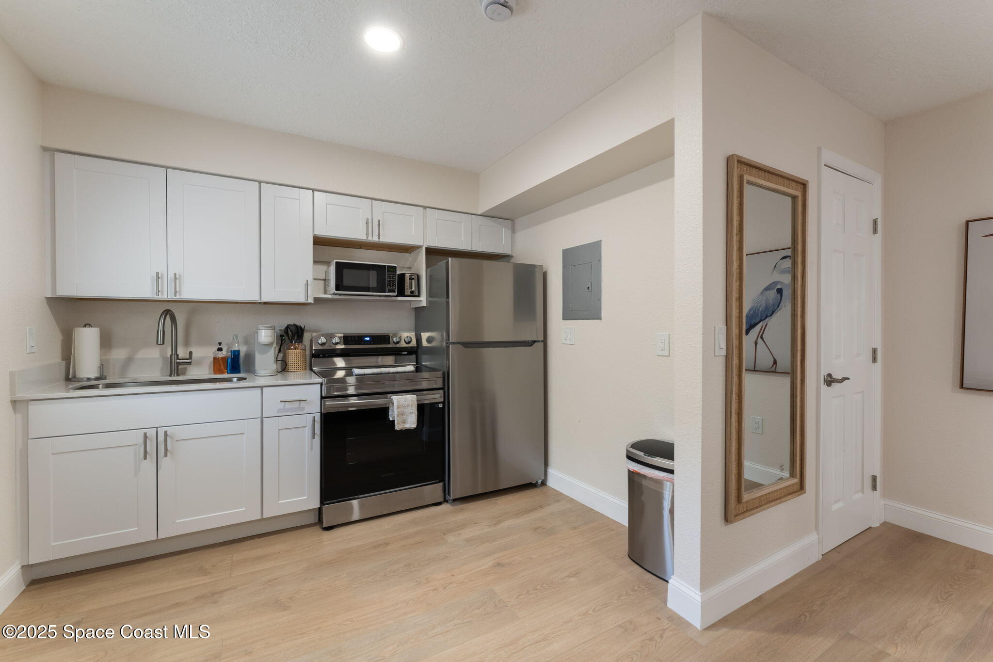 637 South Orlando Avenue Cocoa Beach, FL 32931 - Photo 42 of 83 a kitchen with stainless steel appliances granite countertop a refrigerator and a stove top oven