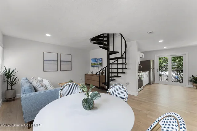 a living room with furniture a refrigerator and a sink