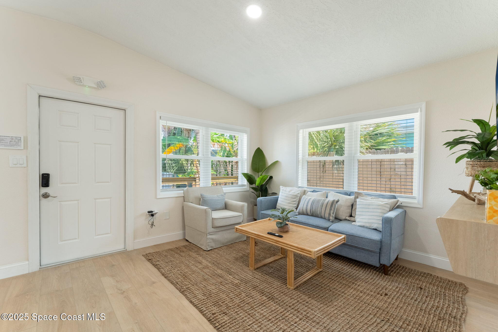 637 South Orlando Avenue Cocoa Beach, FL 32931 - Photo 5 of 83 a living room with furniture and a large window