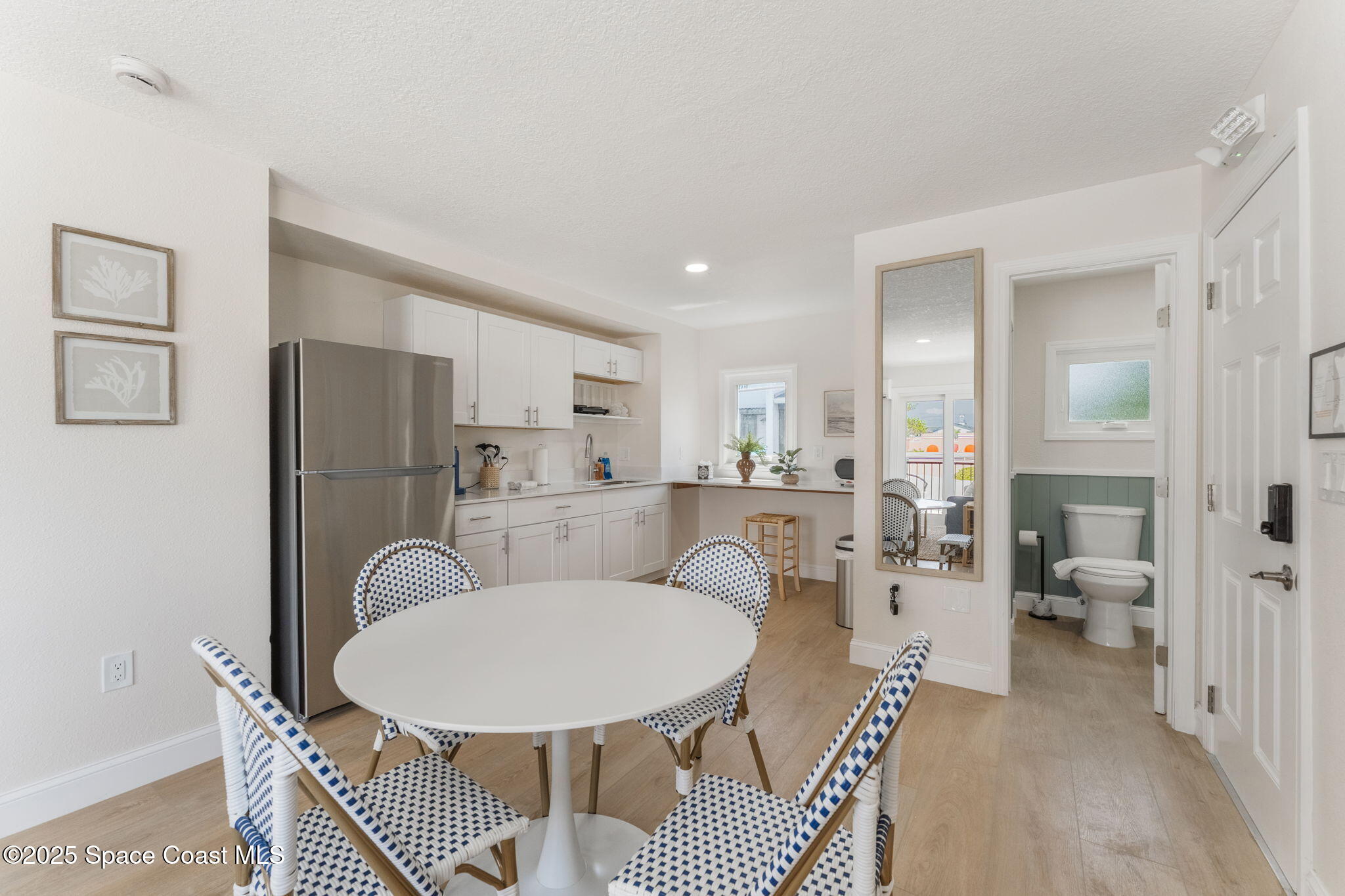 637 South Orlando Avenue Cocoa Beach, FL 32931 - Photo 62 of 83 a living room with stainless steel appliances furniture a rug and a kitchen view