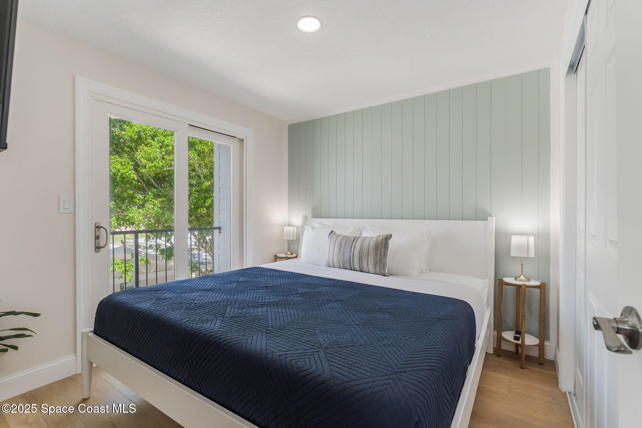 637 South Orlando Avenue Cocoa Beach, FL 32931 - Photo 65 of 83 a bedroom with a large bed and a large window