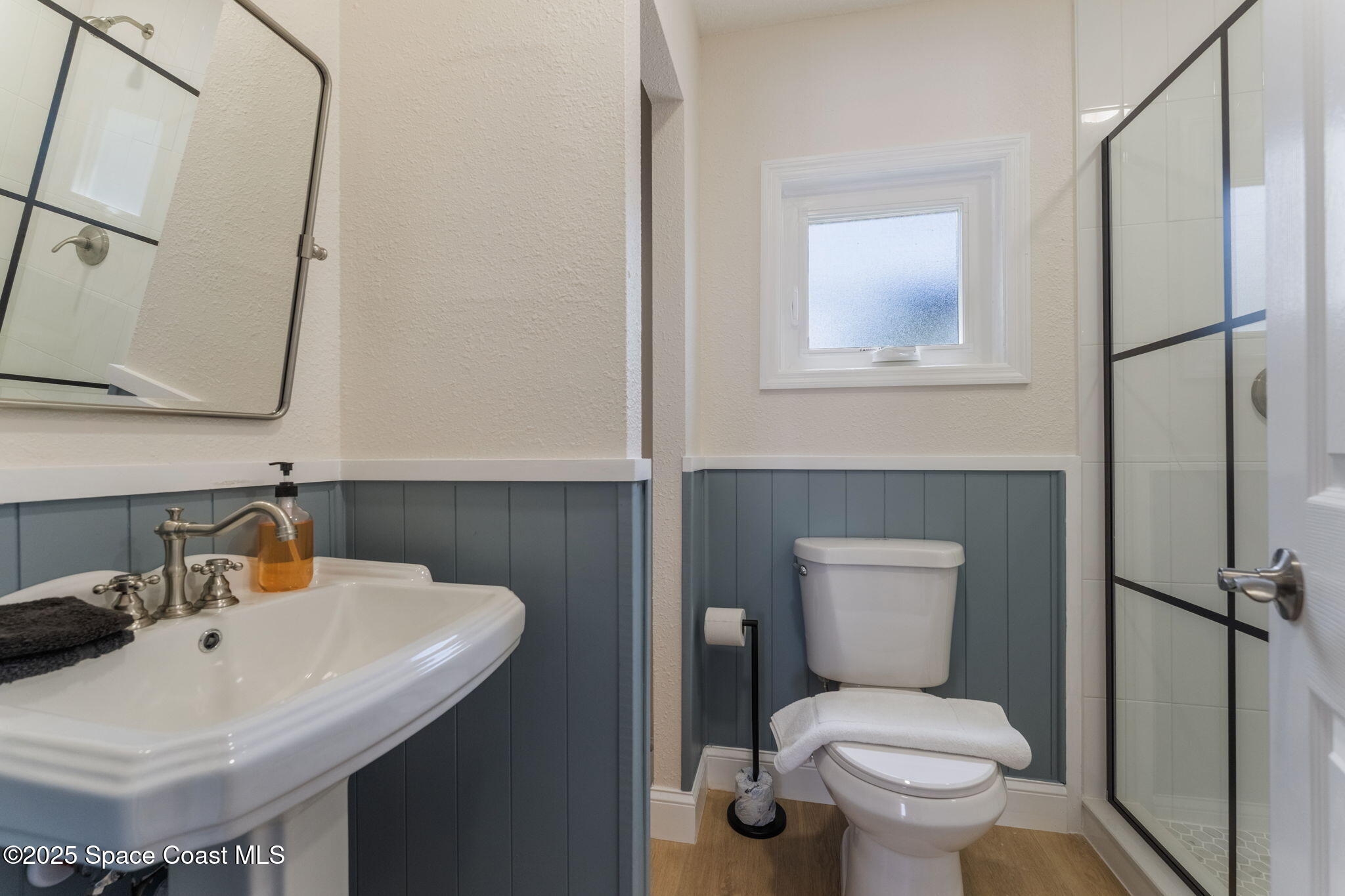 637 South Orlando Avenue Cocoa Beach, FL 32931 - Photo 66 of 83 a bathroom with a toilet sink and mirror