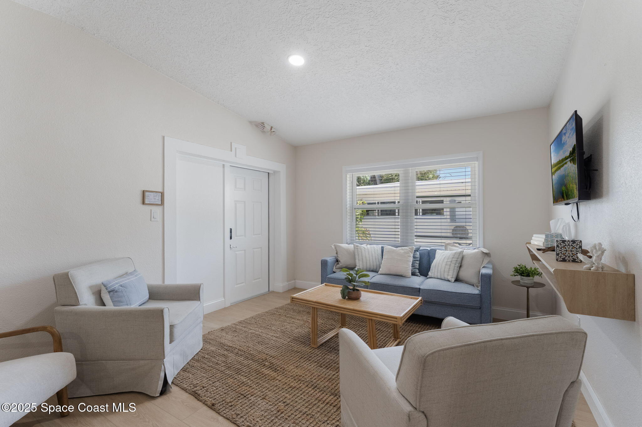 637 South Orlando Avenue Cocoa Beach, FL 32931 - Photo 67 of 83 a living room with furniture and a flat screen tv