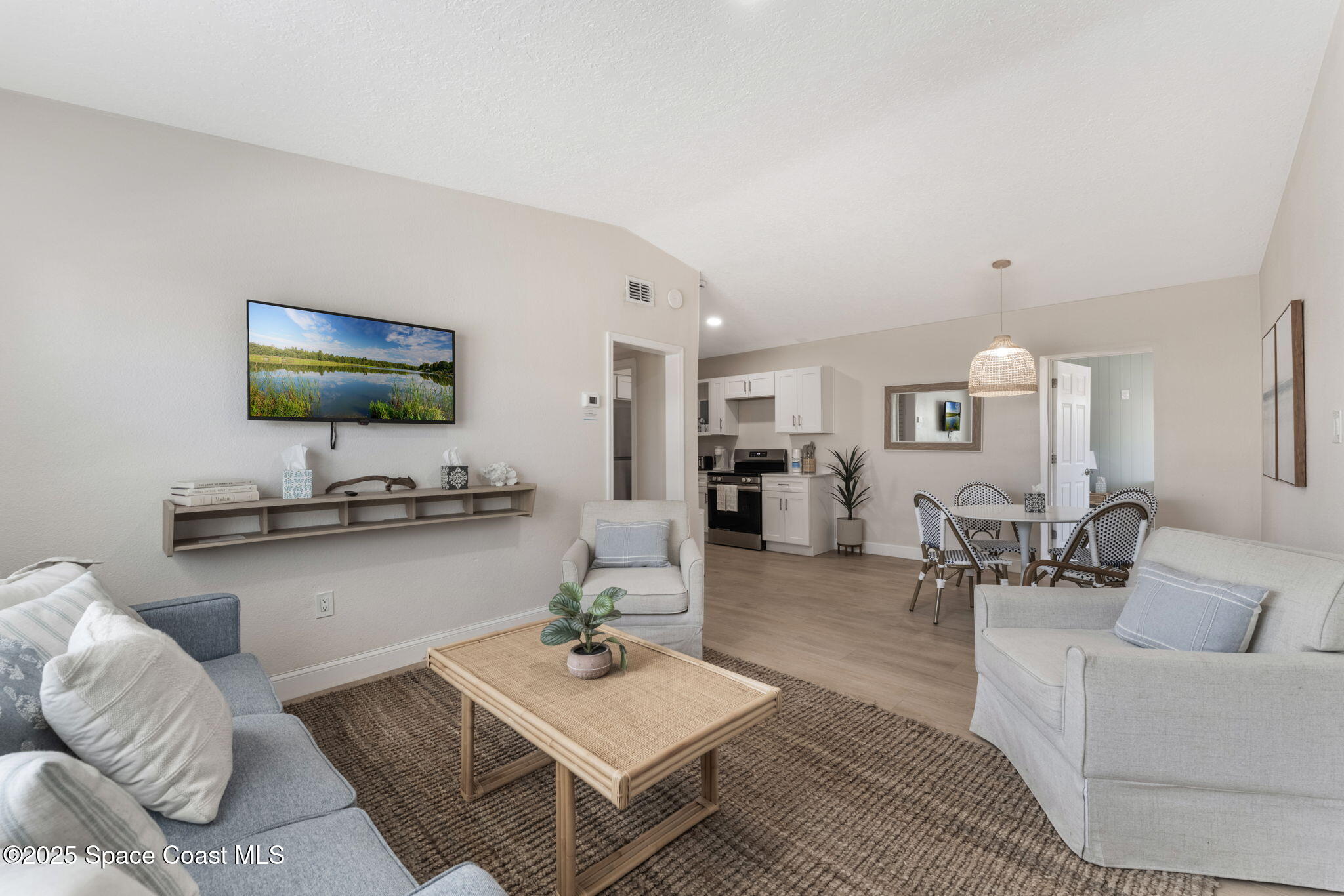 637 South Orlando Avenue Cocoa Beach, FL 32931 - Photo 68 of 83 a living room with furniture and a flat screen tv