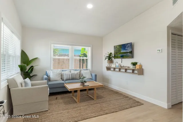 a room with a bed and a potted plant