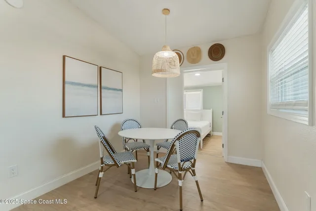 a large bedroom with a bed and a painting on the wall