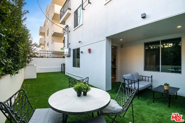 a view of an house with backyard and patio