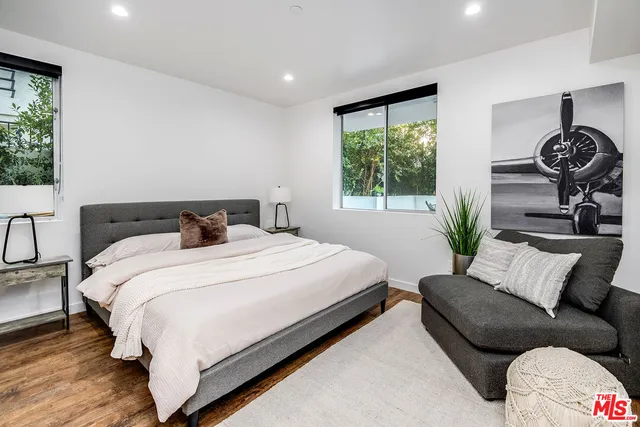 a bedroom with a bed window and couch