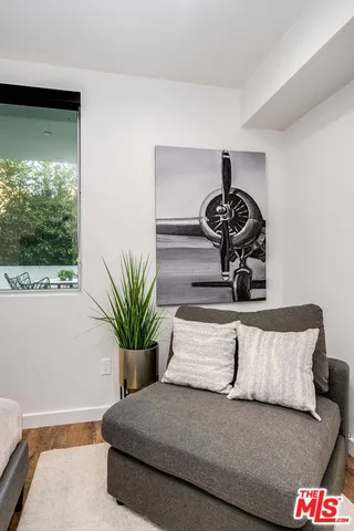 a living room with a couch and a potted plant