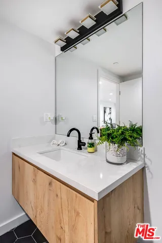 a bathroom with a sink and a mirror