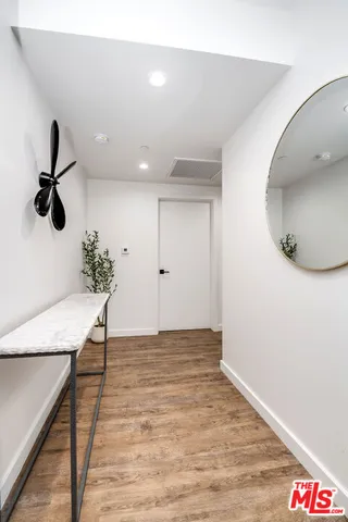 a view of an empty room and wooden floor