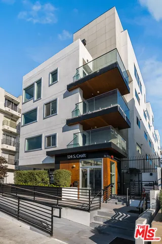 a view of a street with potted plants