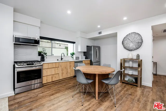 a kitchen with a table chairs and a stove top oven