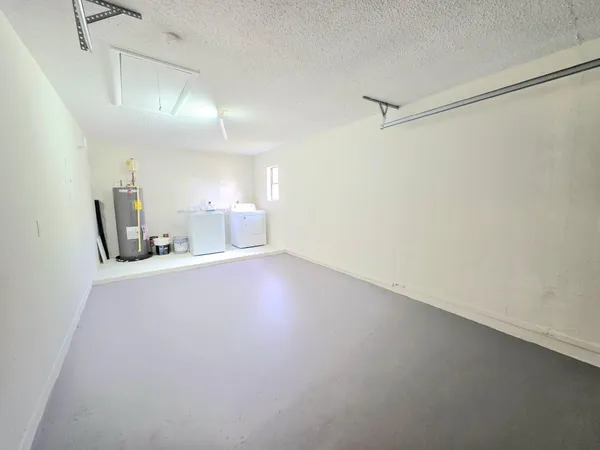 a view of a room with window and a ceiling fan