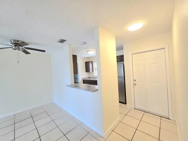 a view of a hallway with bathroom and a shower