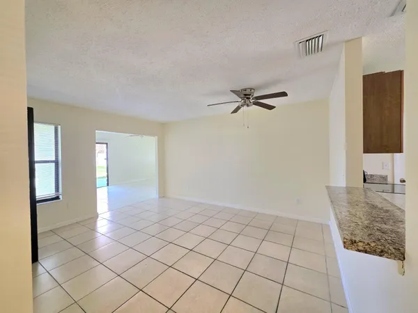 a view of a livingroom with an empty space and a window