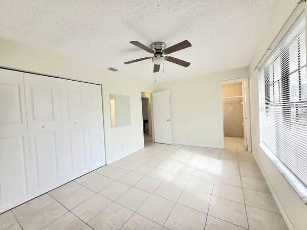 a view of a livingroom with a ceiling fan and window