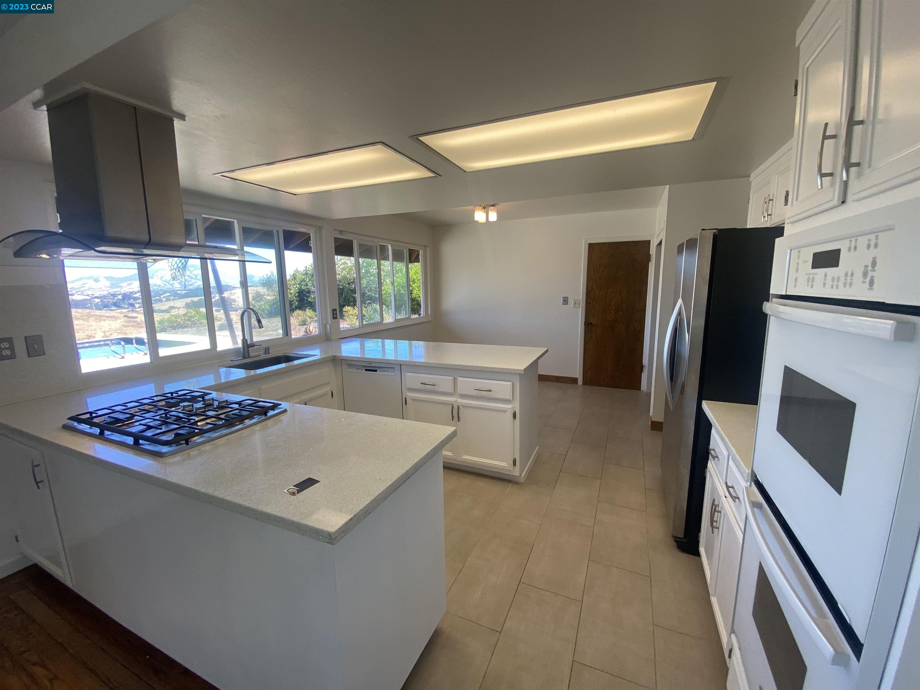 269 Birchwood Drive Moraga, CA 94556 - Photo 11 of 43 a kitchen with stainless steel appliances granite countertop a sink stove and refrigerator