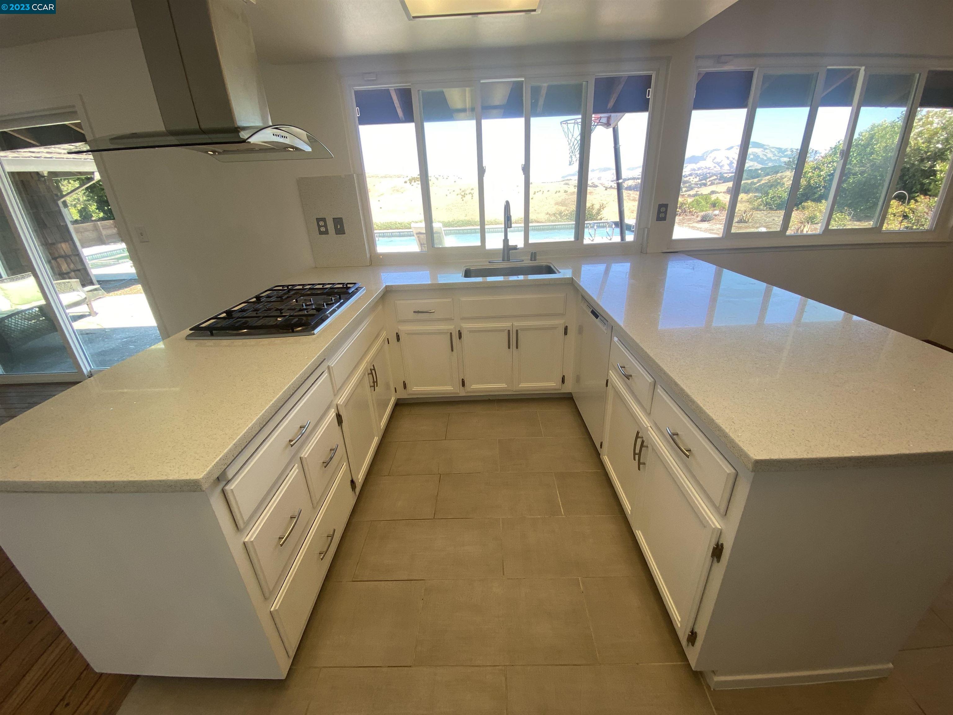 269 Birchwood Drive Moraga, CA 94556 - Photo 14 of 43 a large white kitchen with a large window