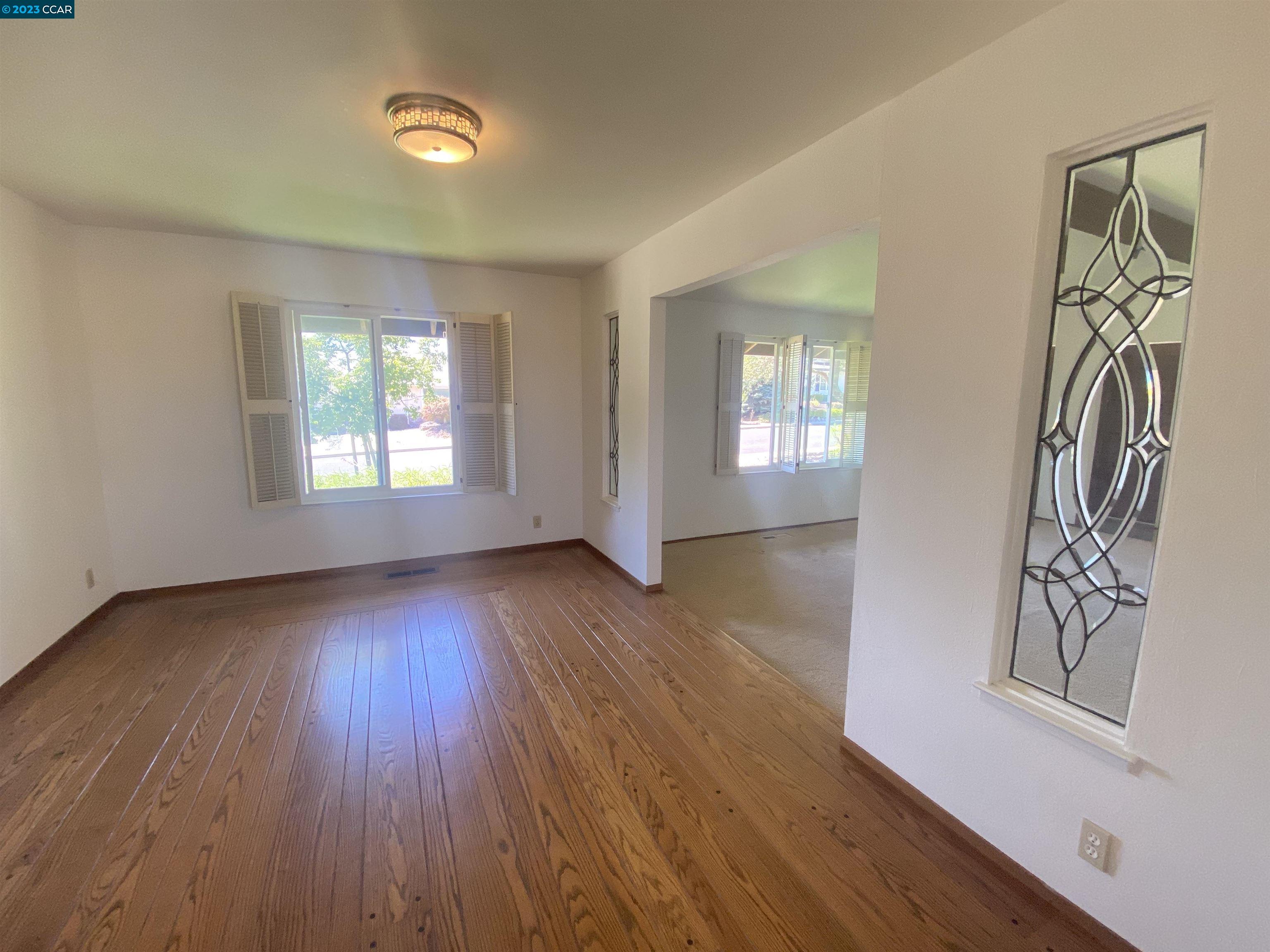 269 Birchwood Drive Moraga, CA 94556 - Photo 16 of 43 an empty room with wooden floor and windows