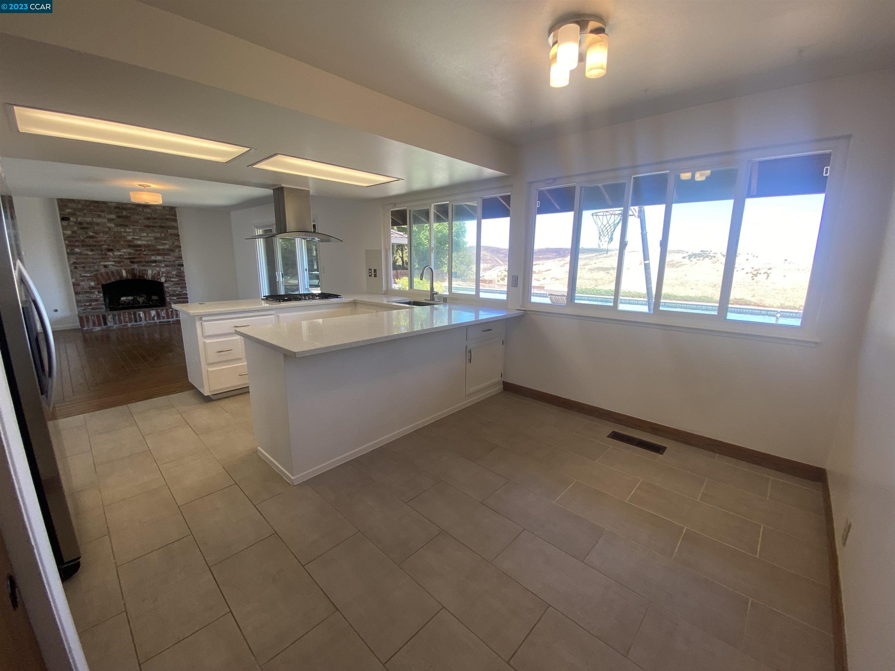 269 Birchwood Drive Moraga, CA 94556 - Photo 21 of 43 a large white kitchen with a large window