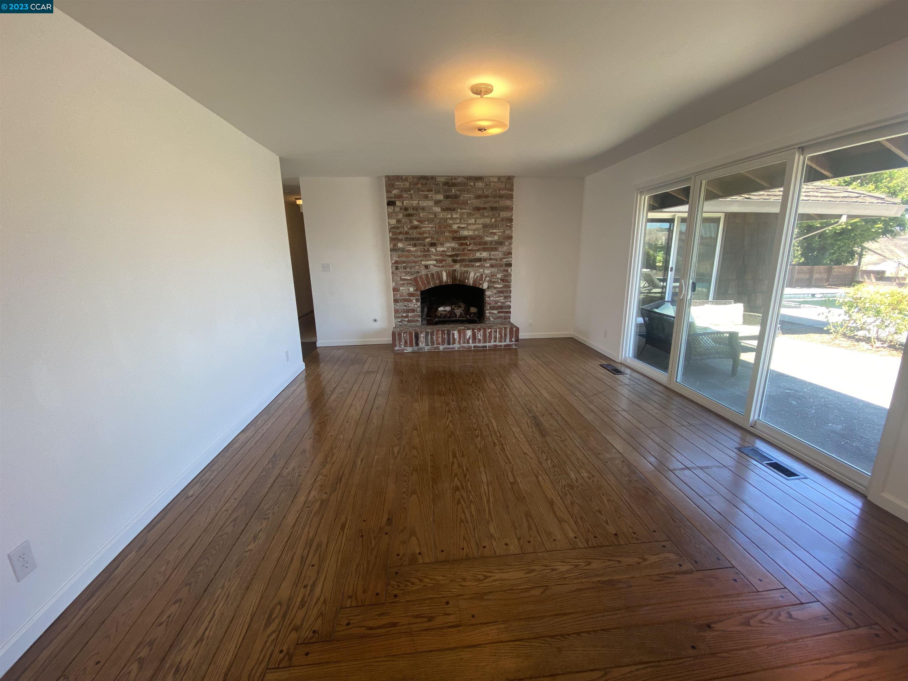 269 Birchwood Drive Moraga, CA 94556 - Photo 22 of 43 a view of empty room with wooden floor and fireplace