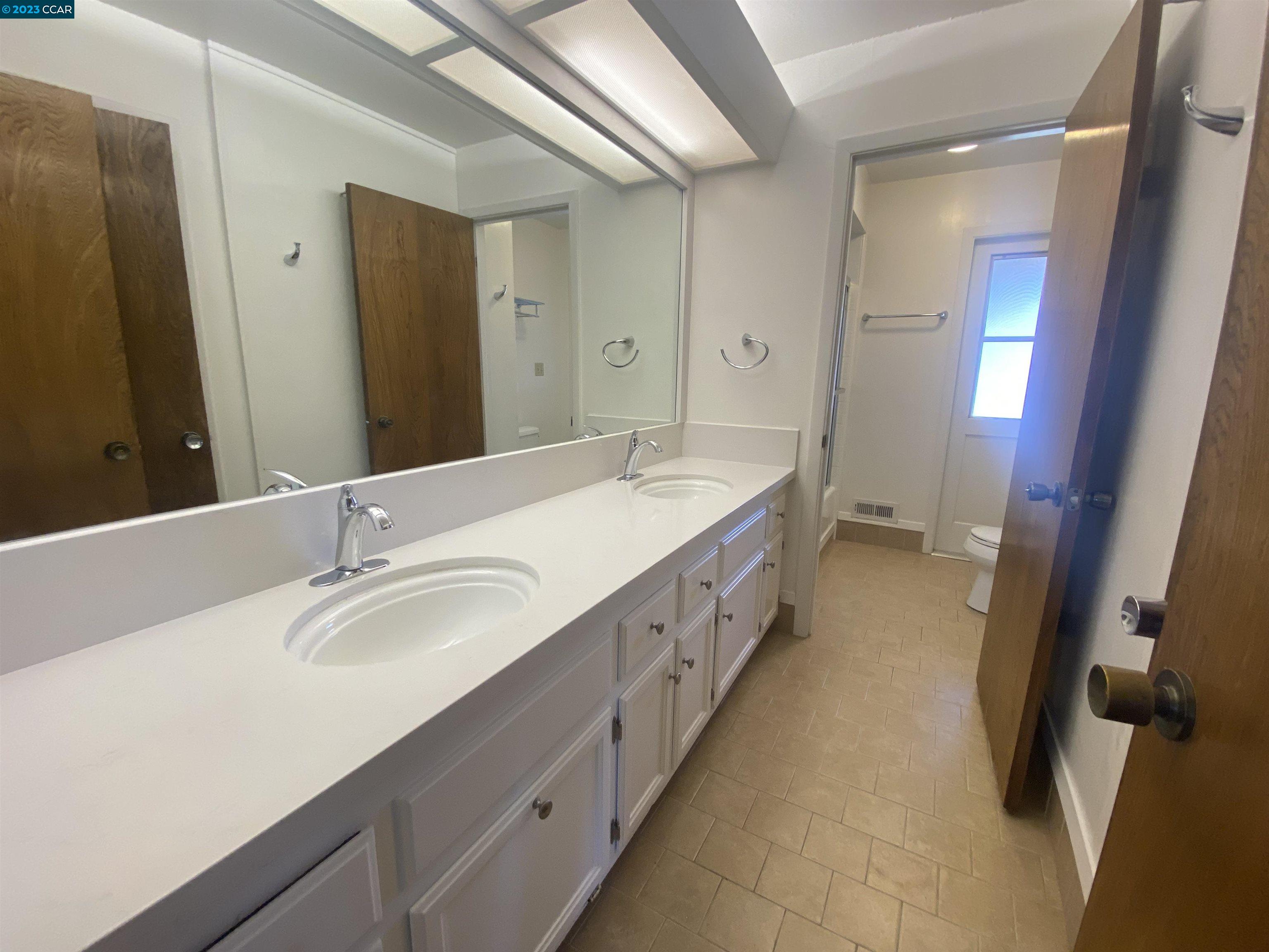 269 Birchwood Drive Moraga, CA 94556 - Photo 32 of 43 a spacious bathroom with double vanity and mirrors