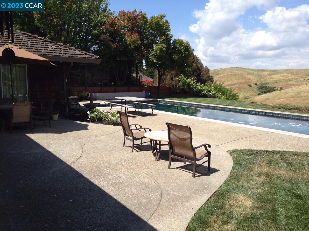 269 Birchwood Drive Moraga, CA 94556 - Photo 6 of 43 a view of a swimming pool with chair and tables