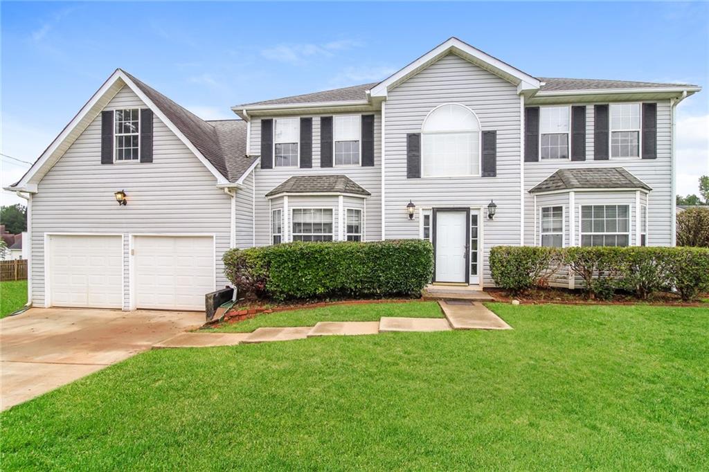 2360 Bankside Circle Decatur, GA 30035 - Photo 1 of 1 a front view of a house with a yard and garage