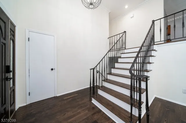 a view of entryway with wooden floor and stairs