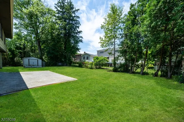 an aerial view of a house with yard and outdoor seating