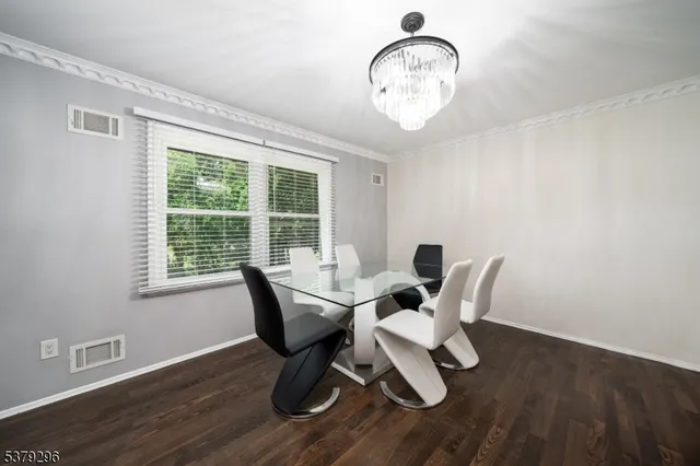 a view of a dining room with furniture wooden floor and a window