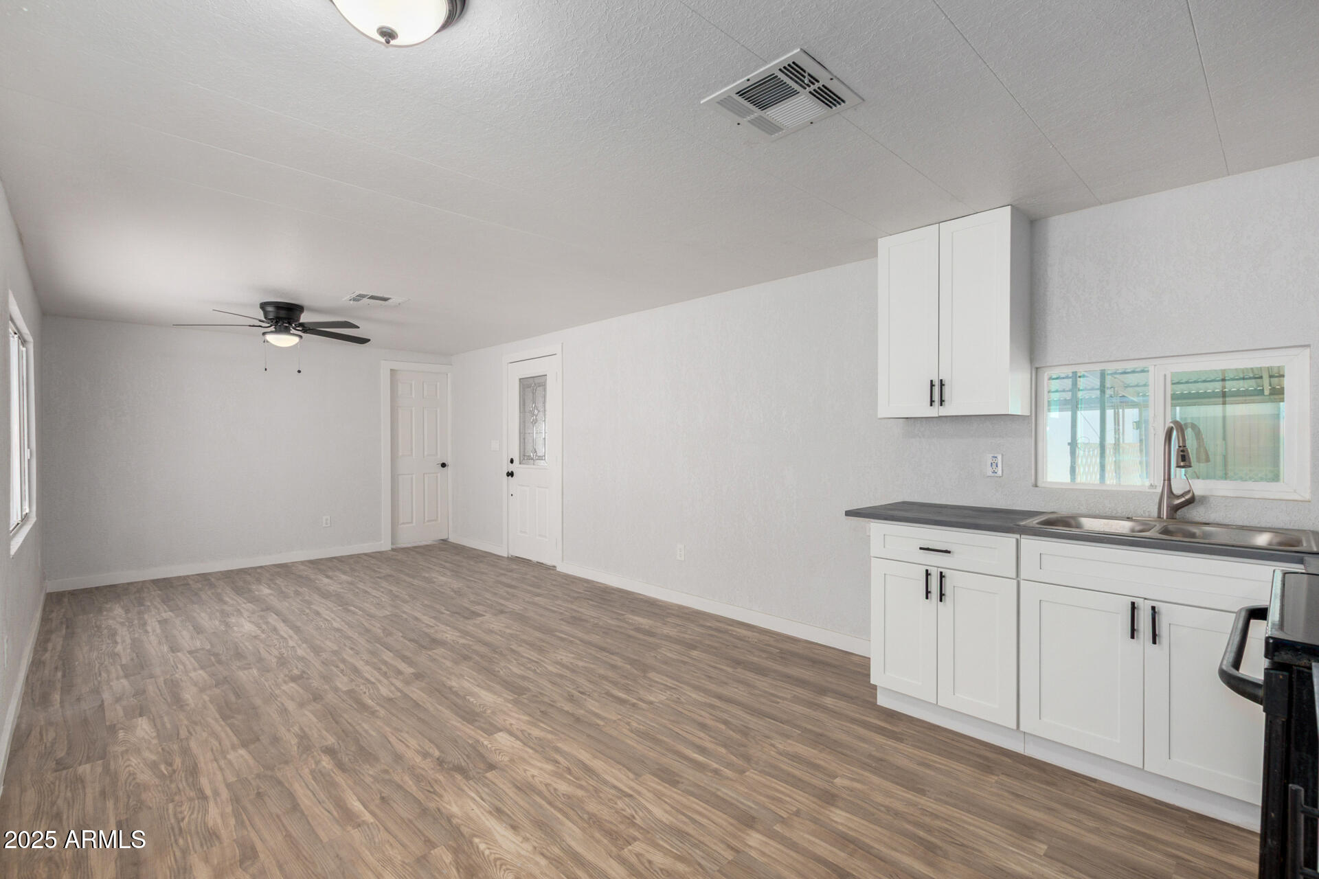 2050 West Dunlap Avenue, Unit D42 Phoenix, AZ 85021 - Photo 17 of 30 an empty room with wooden floor and windows