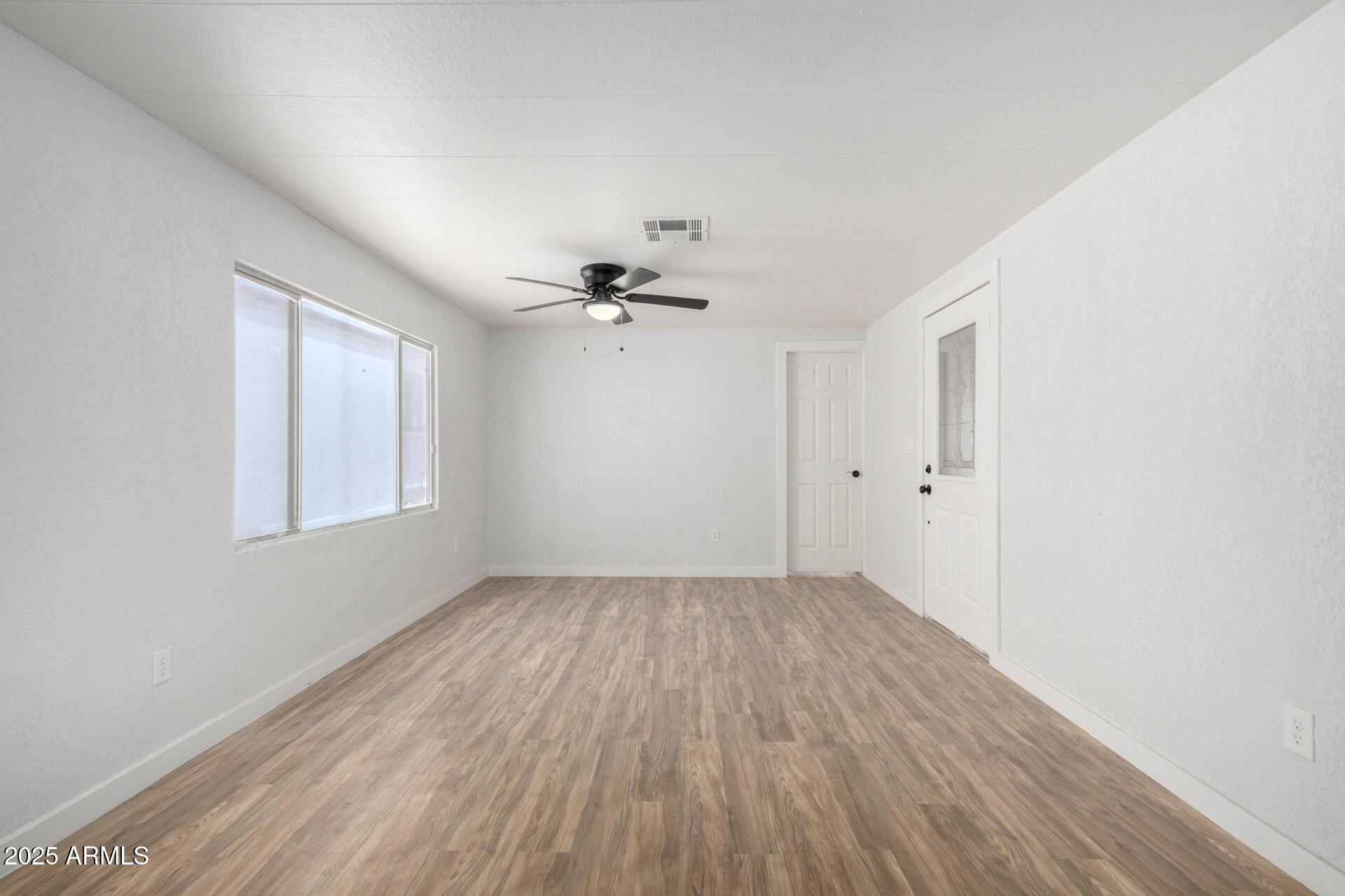 2050 West Dunlap Avenue, Unit D42 Phoenix, AZ 85021 - Photo 18 of 30 wooden floor in an empty room with a window