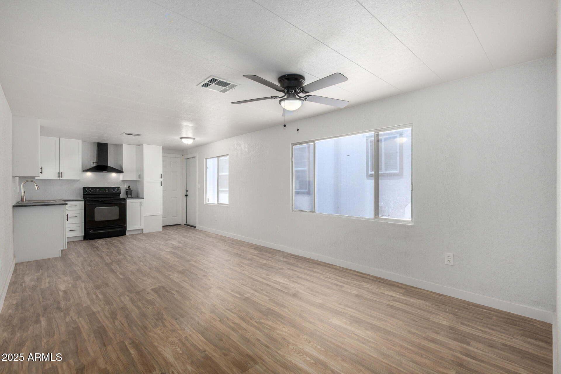 2050 West Dunlap Avenue, Unit D42 Phoenix, AZ 85021 - Photo 6 of 30 a view of an empty room with window and cabinet