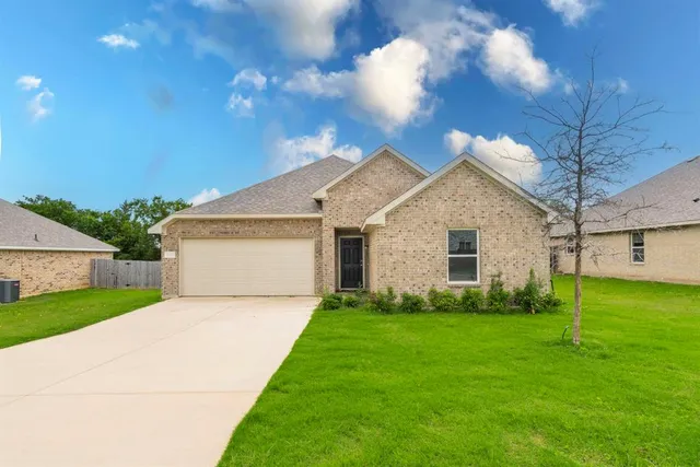 a front view of house with yard and green space