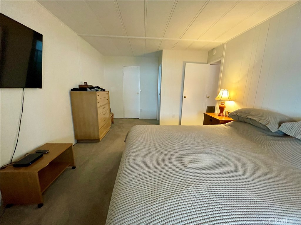 31130 South General Kearny Road, Unit 145 Temecula, CA 92591 - Photo 16 of 27 a bedroom with a bed and a flat screen tv